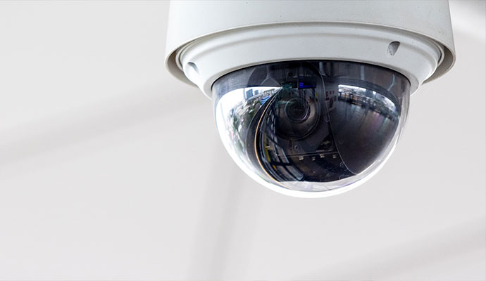 Commercial dome security camera on a white ceiling
