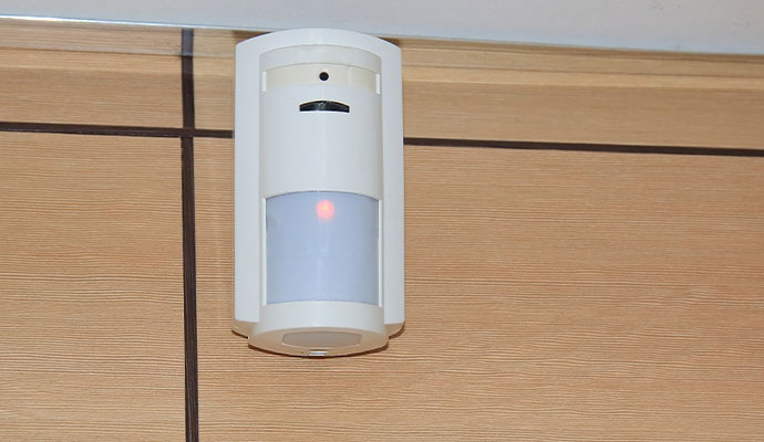 Motion detector mounted on wood paneling