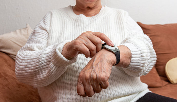 Senior person using a medical alert bracelet