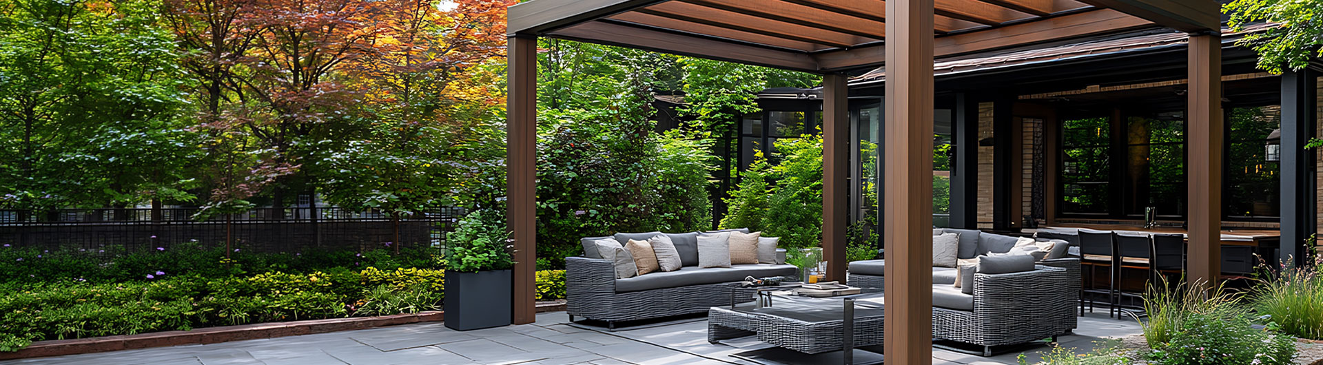 Outdoor living pergola patio with woven sectional furniture and stone flooring