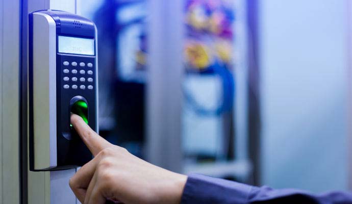 Person using biometric fingerprint scanner to gain access