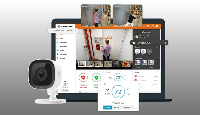  Alarm.com business security interface on a laptop with integrated camera and smart building controls.
