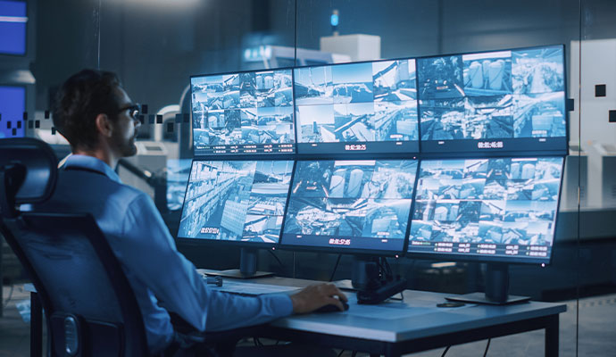 CCTV surveillance operator monitoring screens