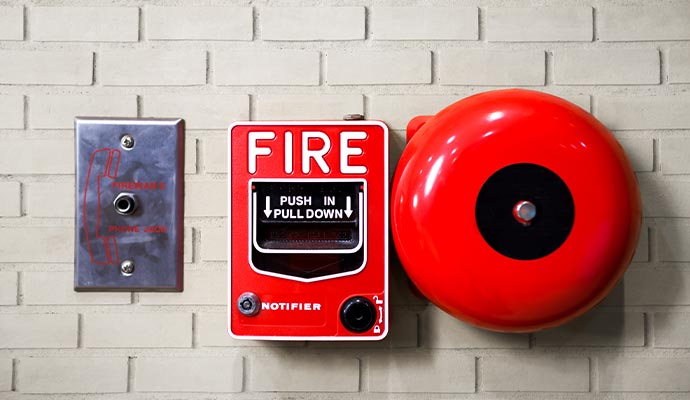 Cellular fire alarm system mounted on the wall