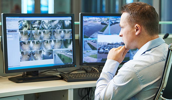 Person monitoring real-time activities of multiple commercial areas