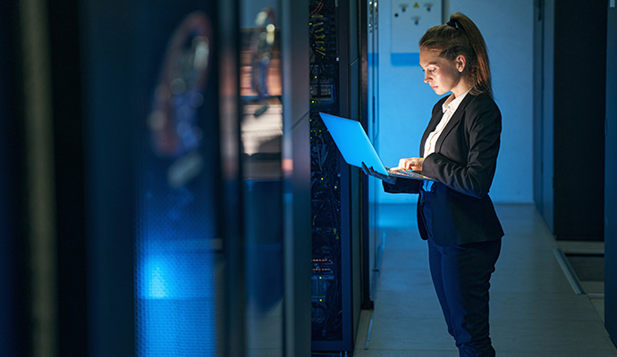 Female IT engineer working in server room