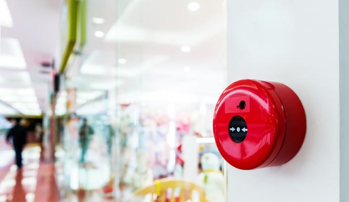 A fire alarm is mounted on a wall in a commercial building