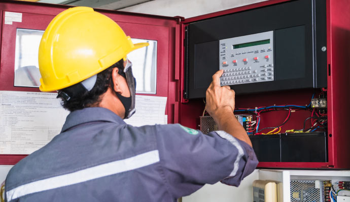Proffesional worker installing conventional fire alarm system