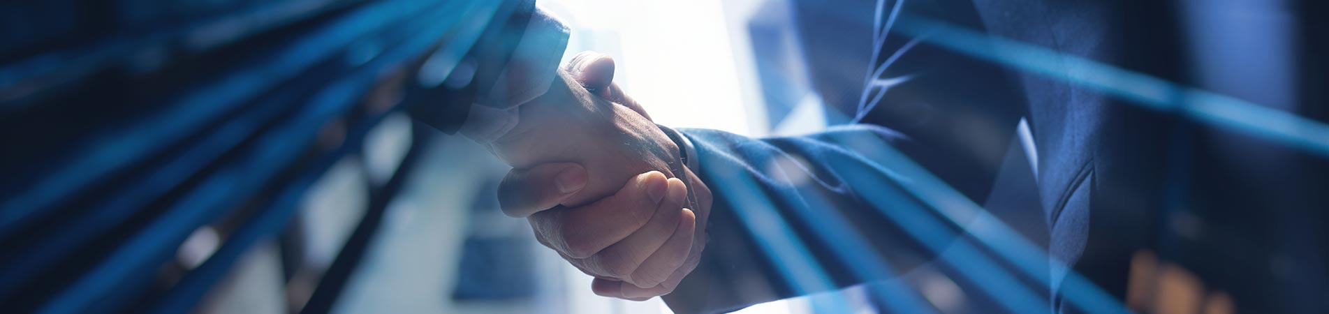 Banner of two business people shaking hands in a commercial office