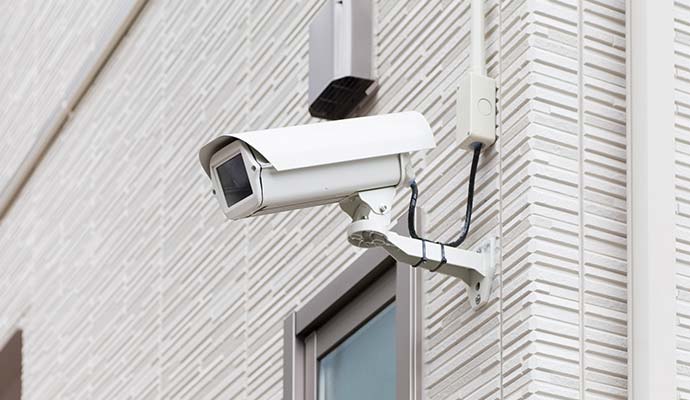 Commercial outdoor bullet security camera mounted on building exterior wall