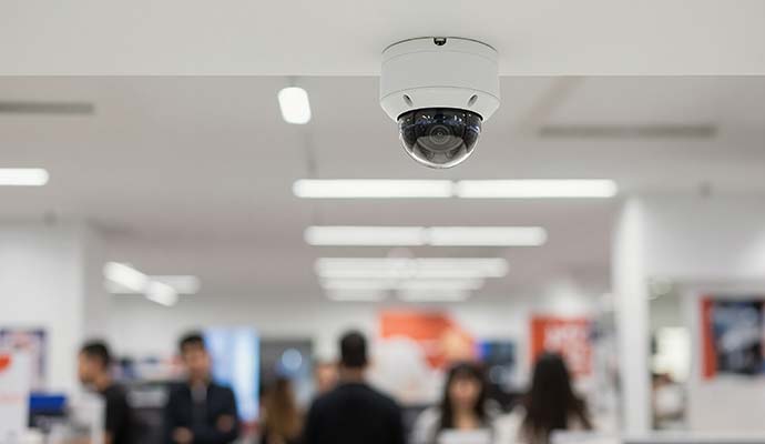 Dome security camera installed on retail store ceiling