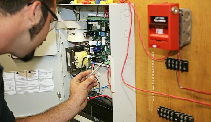Person is maintaining a fire alarm system