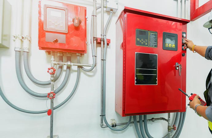 Professional worker repairing fire alarm