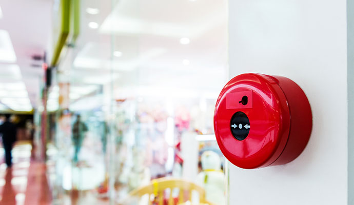 Circular fire alarm button in a shopping mall