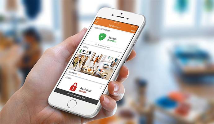 Hand holding smartphone showing live multi-angle retail store video feeds