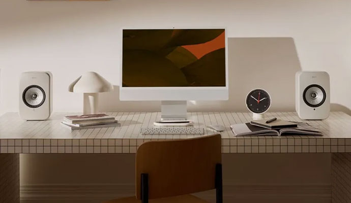 A minimalist home office desk setup featuring a white iMac