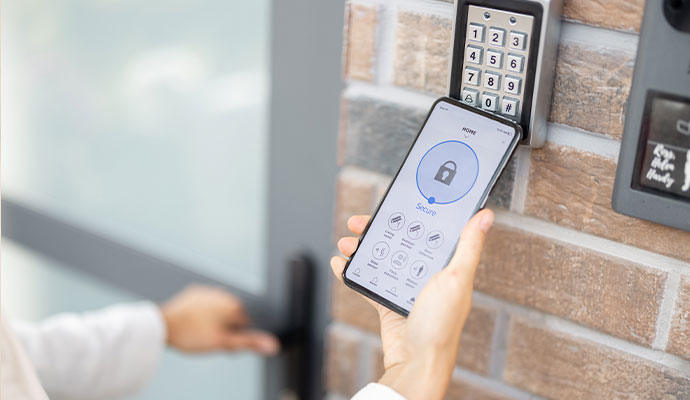 A person holding a smartphone with a home security app