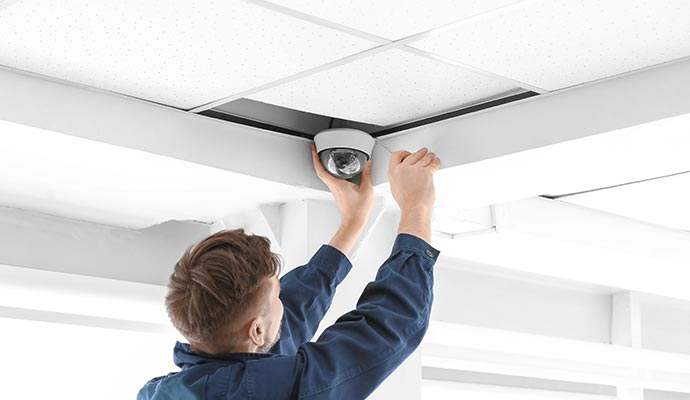 Person installing dome security camera 