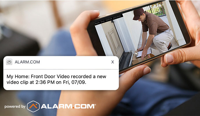 Smartphone displaying front door security camera video alert notification