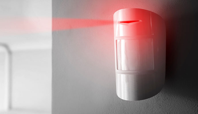 Wall-mounted indoor motion sensor detector with red indicator light