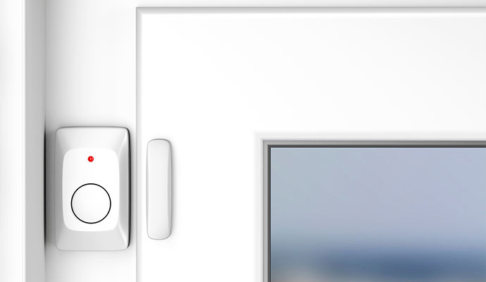 Magnetic contact security sensor installed on white door and window frame