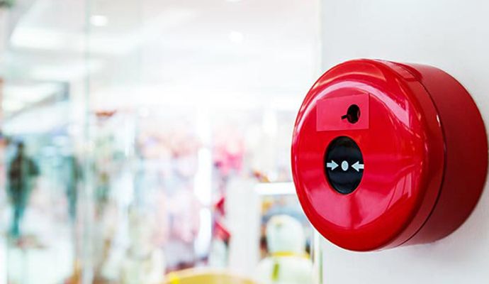 A fire alarm is mounted on a wall in a commercial building