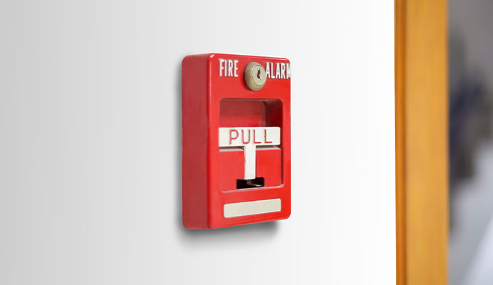Commercial fire alarm emergency pull station on wall