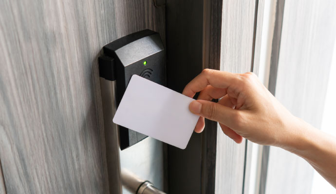 Person using a keycard to unlock an electronic access control door system