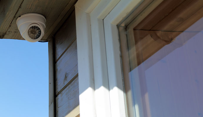 Outdoor dome security camera installed under roof eave