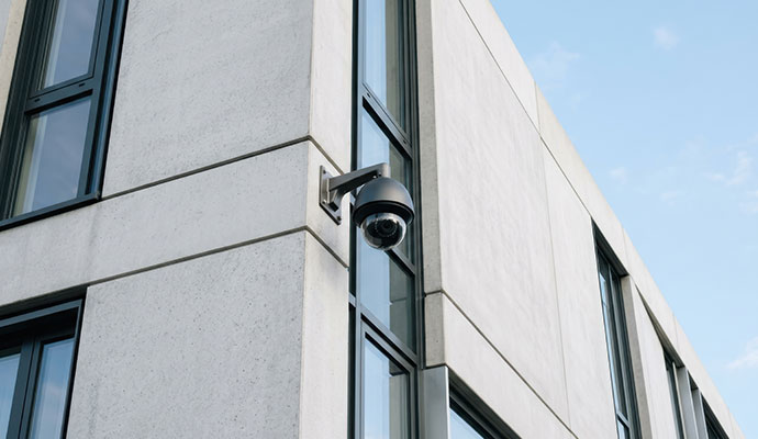 Wireless outdoor dome security camera on building corner