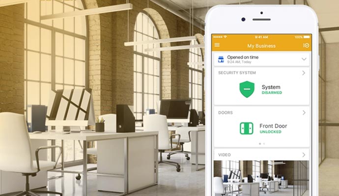 Smartphone displaying a security monitoring app in a modern office