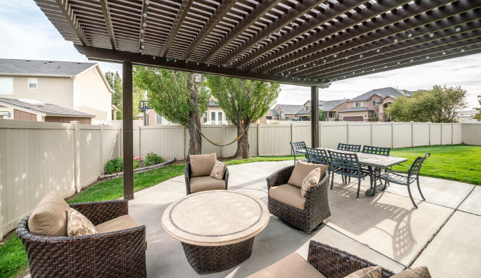 Outdoor backyard patio with pergola and seating area