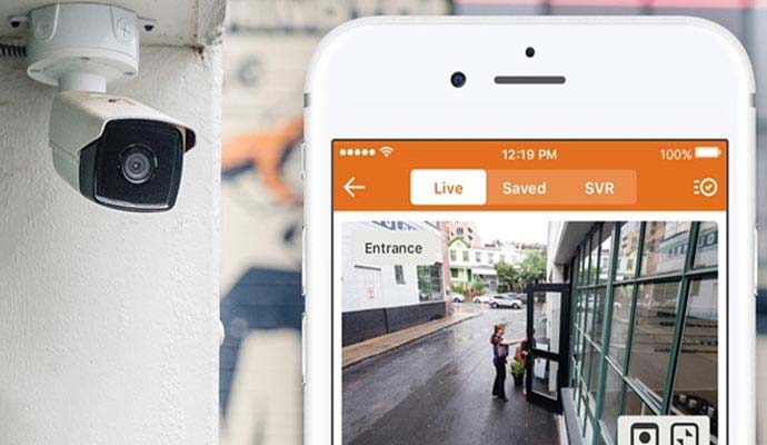 Outdoor bullet security camera monitoring entrance with mobile app preview