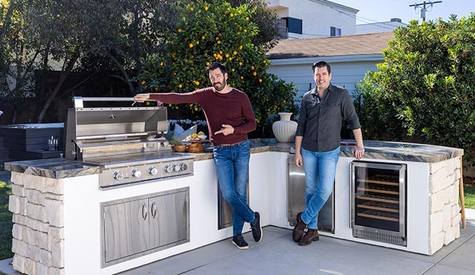 Modern outdoor kitchen living space with built in grill storage and entertainment area for homeowners