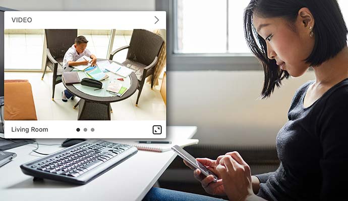 Person monitoring live video feed on smartphone