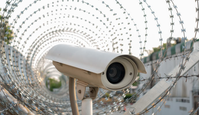 A camera installed perimeter of concertina razor wire.