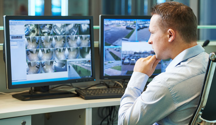 Security operator watching live CCTV cameras