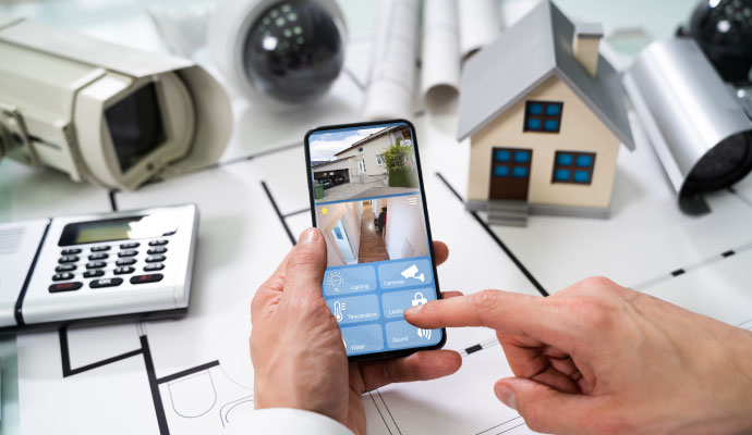 Person using a smartphone to control and monitor a smart home security system