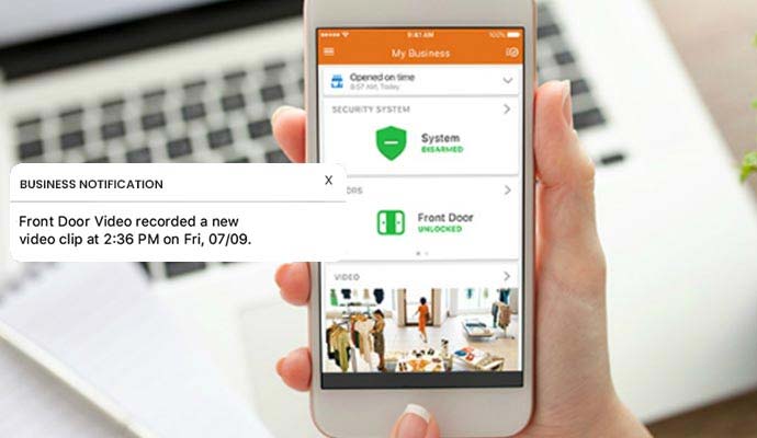 Smartphone displaying business notification for front door video recording