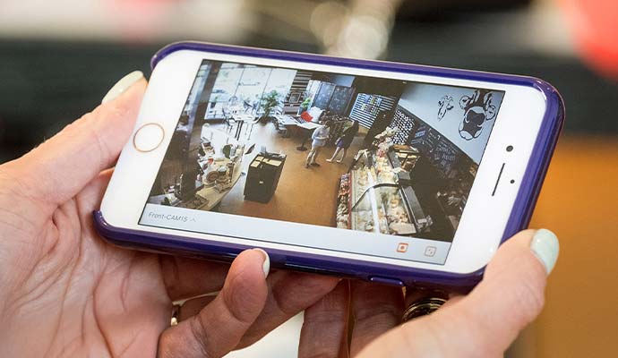 Smartphone displaying live commercial retail store surveillance camera feed