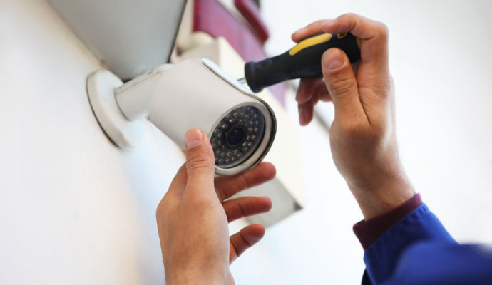 Technician installing an outdoor security camera
