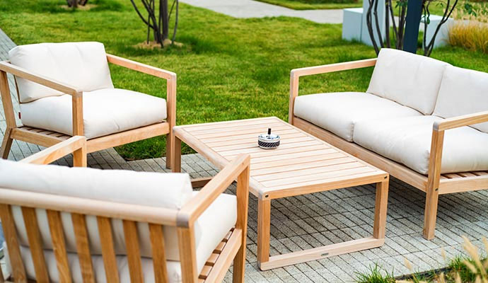 Wooden outdoor patio furniture set with cushioned chairs and sofa