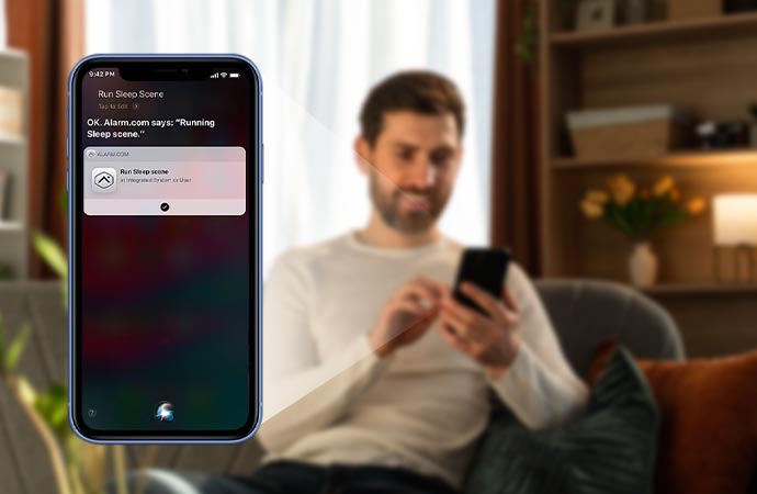 A young man focused on watching something on a smartphone screen.